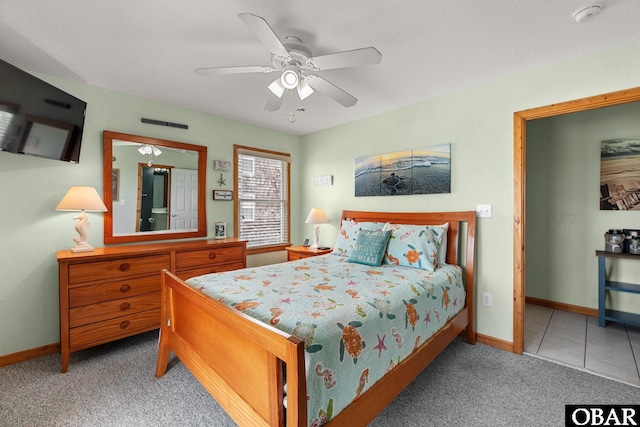 bedroom featuring carpet floors, visible vents, a ceiling fan, tile patterned flooring, and baseboards