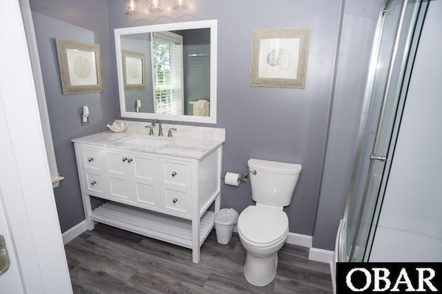 full bathroom featuring baseboards, vanity, toilet, and wood finished floors