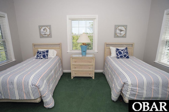 carpeted bedroom featuring multiple windows and baseboards