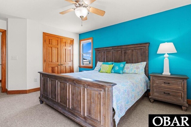 bedroom featuring light carpet, ceiling fan, and baseboards