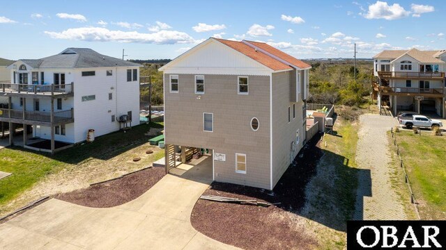 rear view of house with a residential view and driveway