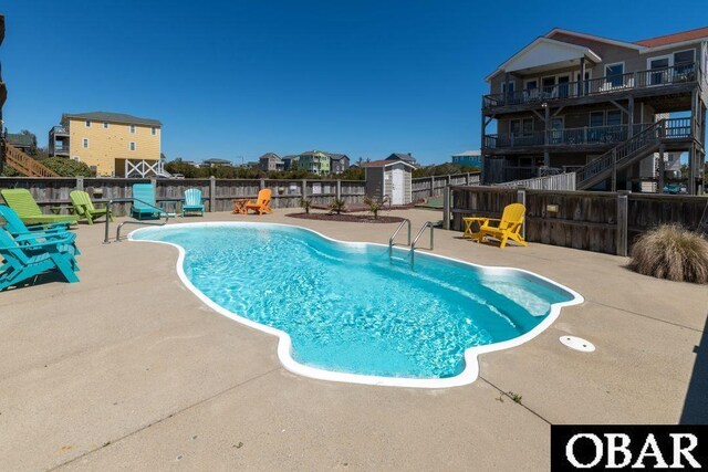 view of pool with a fenced in pool, a patio, and fence