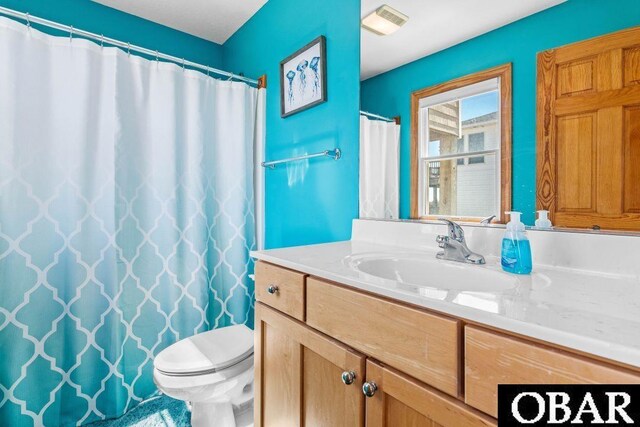 bathroom featuring visible vents, vanity, and toilet