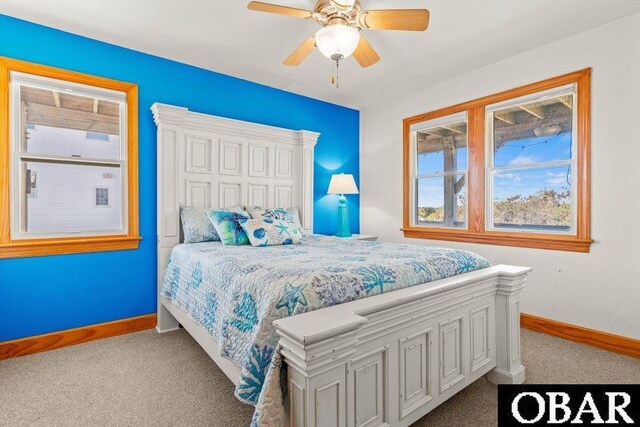 bedroom featuring light colored carpet, ceiling fan, and baseboards