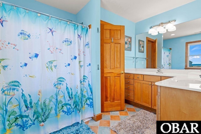 full bathroom featuring tile patterned floors and vanity