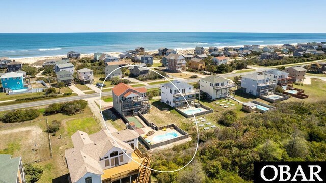 bird's eye view with a water view, a residential view, and a view of the beach