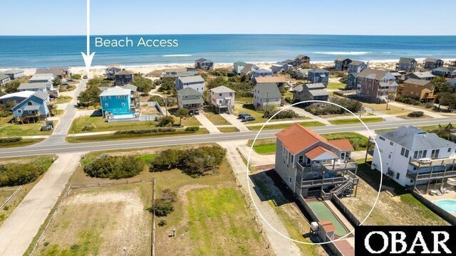 birds eye view of property featuring a water view and a residential view