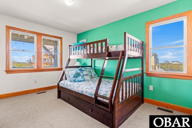 carpeted bedroom featuring visible vents and baseboards