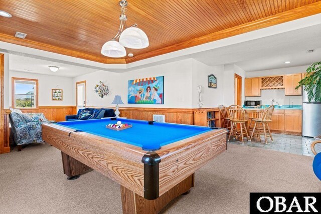 playroom featuring wainscoting, a raised ceiling, wood ceiling, and light colored carpet