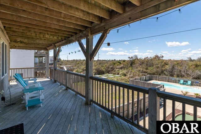 wooden terrace with a fenced in pool