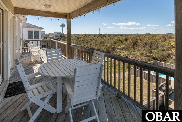 wooden deck with outdoor dining space