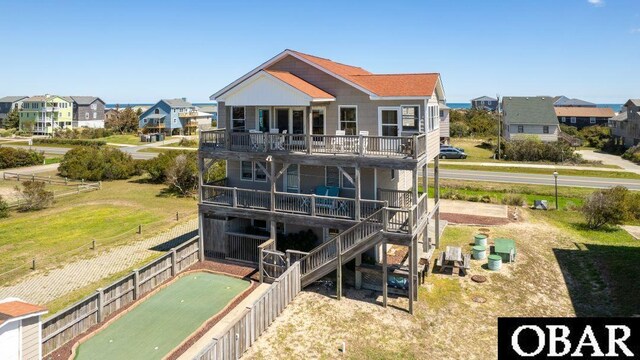 rear view of property featuring a residential view, stairway, fence, and a wooden deck