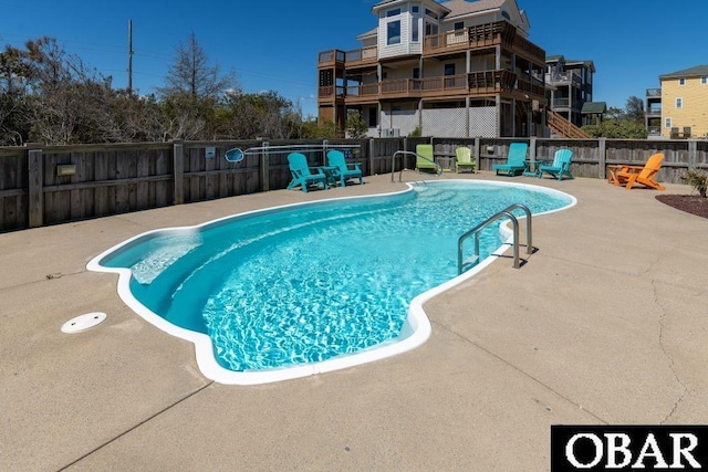 view of swimming pool featuring a fenced in pool, a patio area, and fence