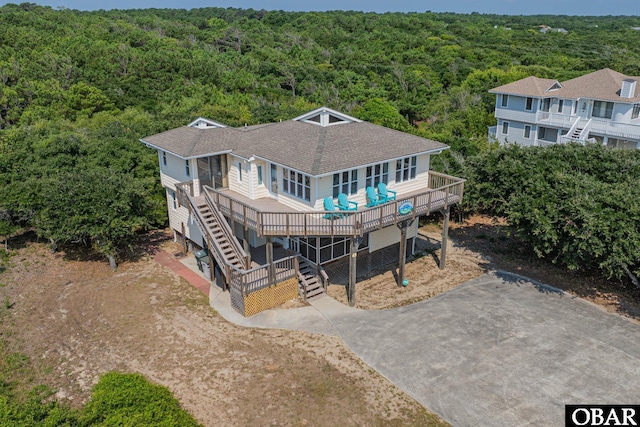 65 Ocean Blvd Lot 3-4, Southern Shores, NC 27949 - back of property with a forest view, a shingled roof, driveway, and stairs