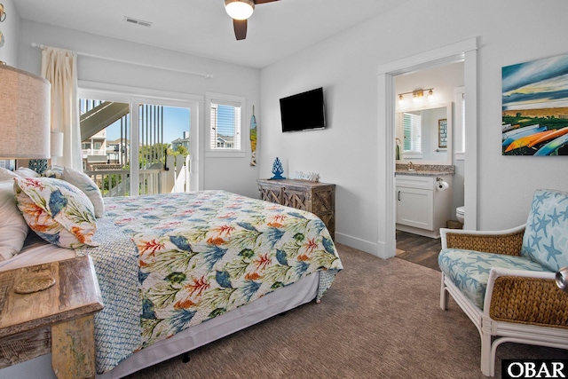 bedroom with access to exterior, connected bathroom, carpet floors, a ceiling fan, and baseboards