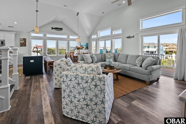 living area with dark wood-style floors, recessed lighting, and high vaulted ceiling