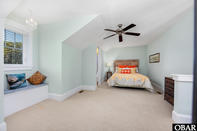 carpeted bedroom featuring visible vents, baseboards, vaulted ceiling, and ceiling fan with notable chandelier