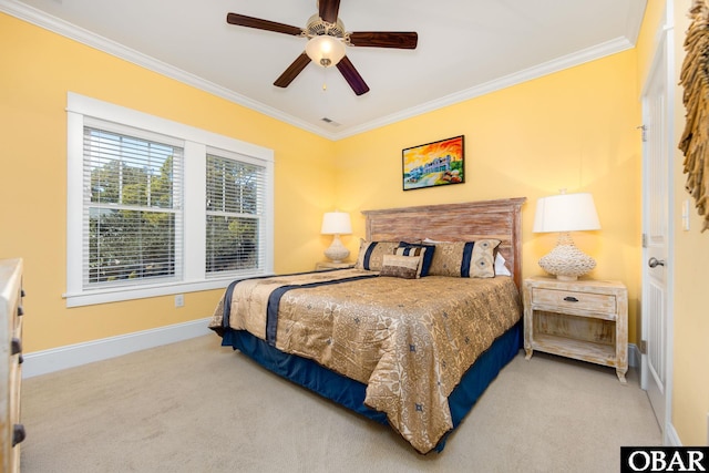 carpeted bedroom featuring baseboards, visible vents, ornamental molding, and a ceiling fan