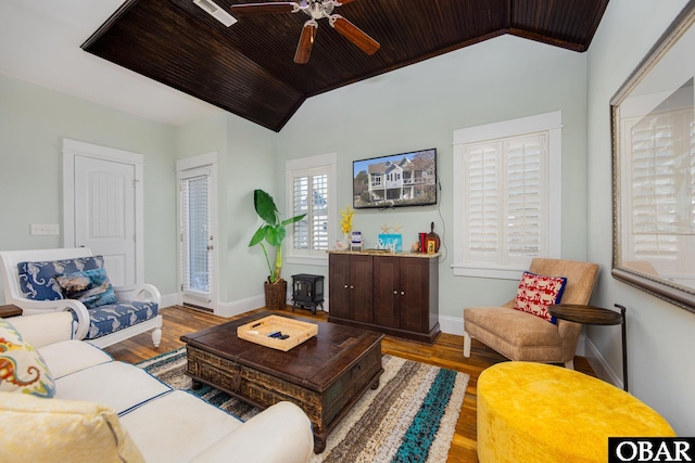 living area with wooden ceiling, vaulted ceiling, and wood finished floors