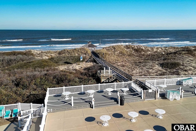 drone / aerial view featuring a beach view and a water view