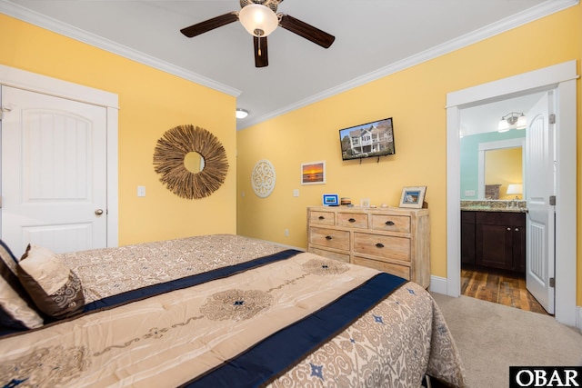 bedroom featuring baseboards, ceiling fan, ornamental molding, wood finished floors, and ensuite bathroom