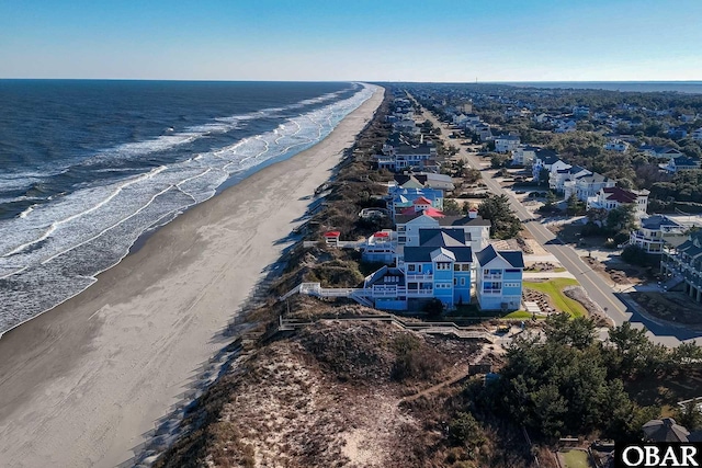 drone / aerial view featuring a view of the beach and a water view