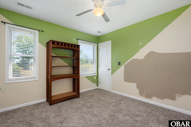 147 Dr Newbern Rd Lot # 3, Powells Point, NC 27966 - spare room with carpet floors, visible vents, a ceiling fan, and a healthy amount of sunlight