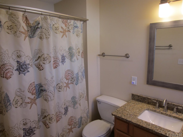 bathroom with toilet, curtained shower, and vanity