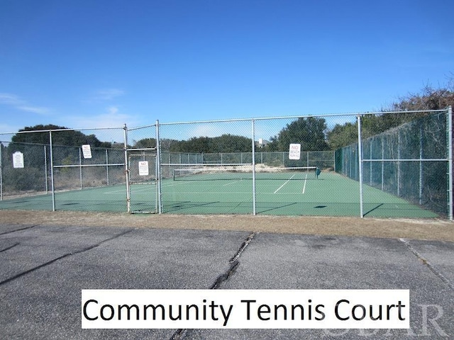 view of sport court featuring fence