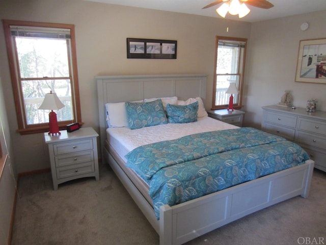 bedroom with a ceiling fan and light carpet