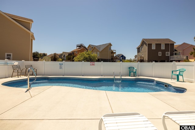 view of swimming pool with a fenced in pool, a residential view, and a fenced backyard