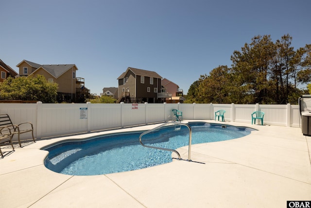 view of swimming pool with a patio, a residential view, a fenced backyard, and a fenced in pool