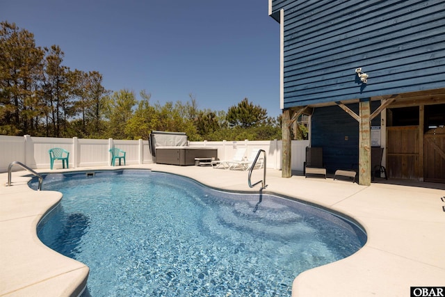 view of pool featuring a fenced in pool, a fenced backyard, a patio, and a hot tub