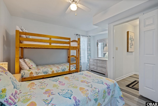 bedroom featuring light wood-style floors, ceiling fan, and baseboards