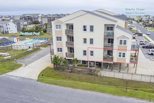 view of property with a residential view and driveway