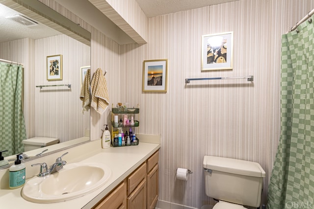 bathroom with toilet, wallpapered walls, and visible vents