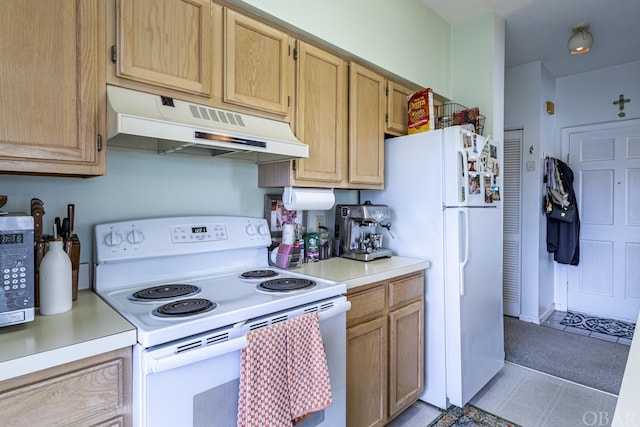 kitchen featuring white appliances, light countertops, under cabinet range hood, and light brown cabinets