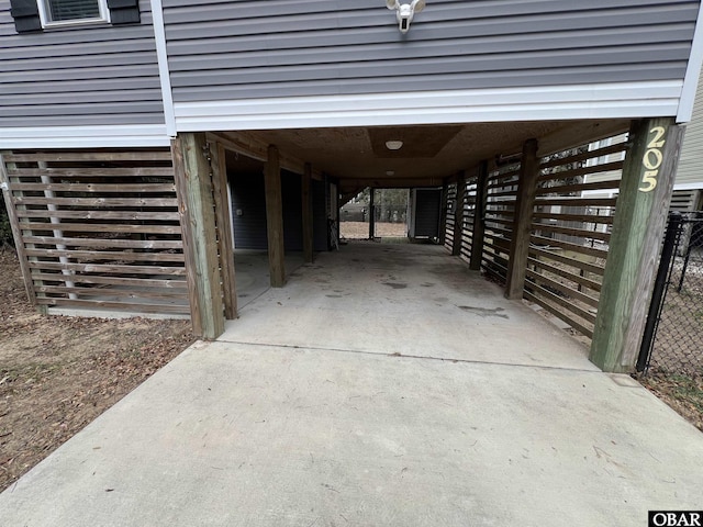 view of parking with a carport and concrete driveway