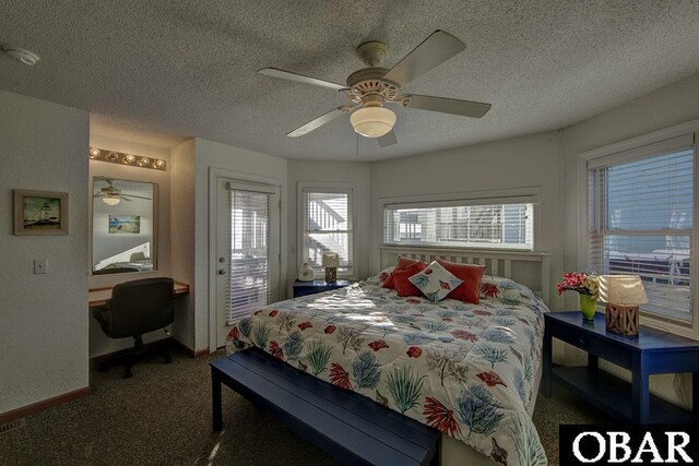 24255 S Shore Dr Lot # 9, Rodanthe, NC 27968 - carpeted bedroom featuring multiple windows, a textured ceiling, an office area, baseboards, and ceiling fan