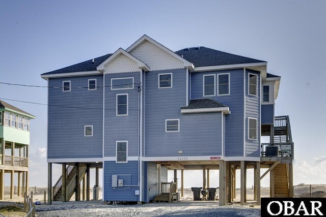 24255 S Shore Dr Lot # 9, Rodanthe, NC 27968 - back of house featuring a carport, stairs, driveway, and central air condition unit