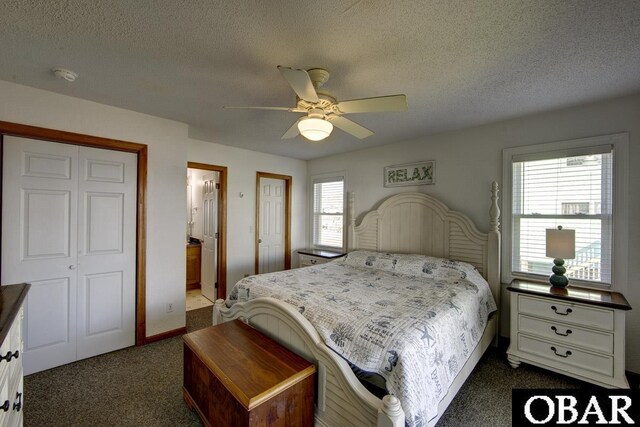 24255 S Shore Dr Lot # 9, Rodanthe, NC 27968 - bedroom with dark colored carpet, a textured ceiling, ceiling fan, and ensuite bath