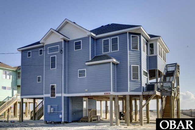 24255 S Shore Dr Lot # 9, Rodanthe, NC 27968 - back of property with a carport, stairs, dirt driveway, a deck, and central AC