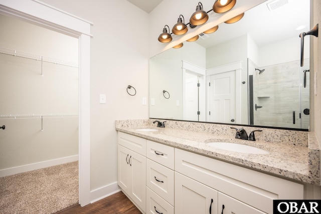 329 Country Club Rd Lot A, Lot A, Camden, NC 27921 - bathroom with double vanity, a stall shower, baseboards, a spacious closet, and wood finished floors