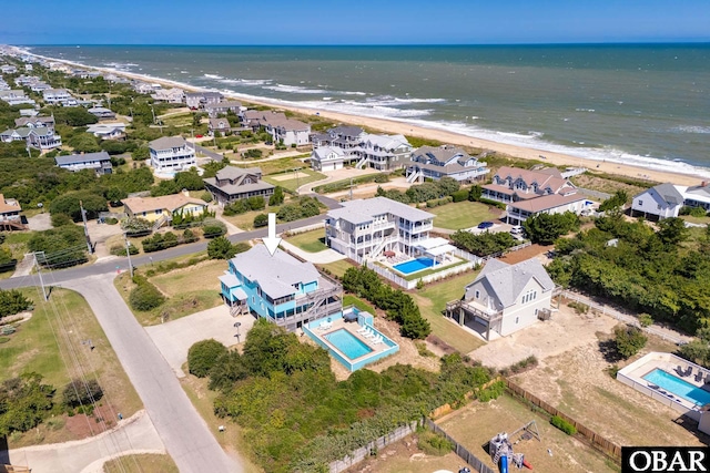 birds eye view of property featuring a residential view, a water view, and a beach view