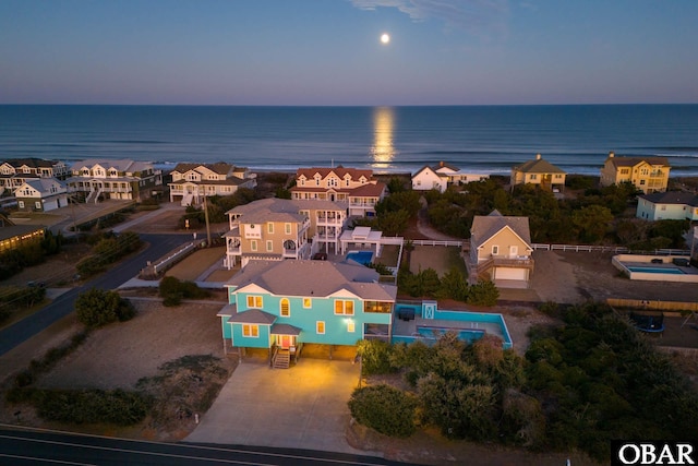 drone / aerial view featuring a water view and a residential view