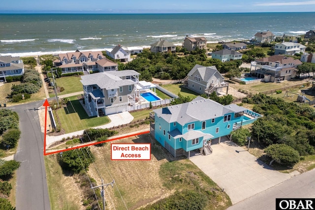 drone / aerial view featuring a water view and a residential view