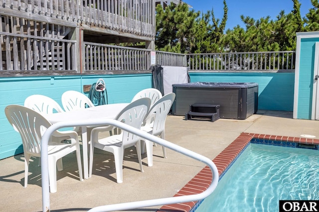 view of pool with a hot tub, a pool, and a patio