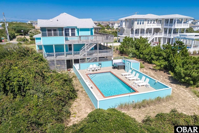 rear view of house featuring a patio and a community pool