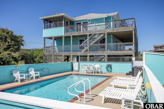 community pool featuring a patio area and stairway