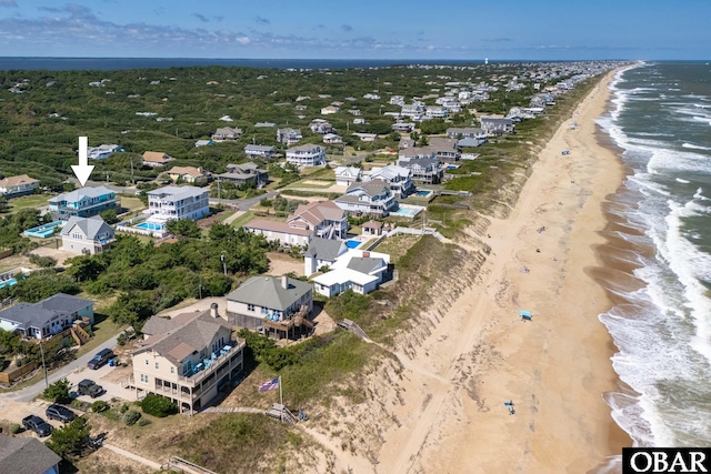 drone / aerial view with a beach view, a residential view, and a water view